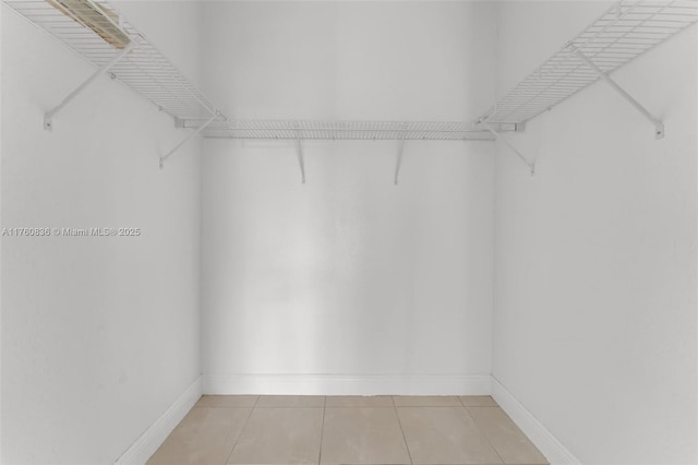 spacious closet with light tile patterned floors