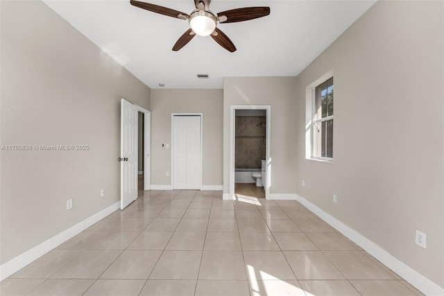 unfurnished bedroom featuring visible vents, a ceiling fan, a closet, light tile patterned flooring, and baseboards