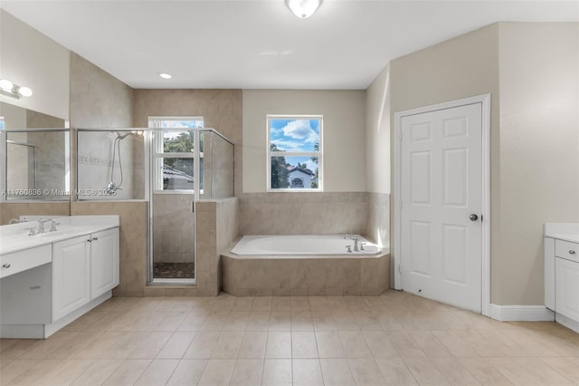 bathroom with a stall shower, tile patterned floors, a garden tub, and vanity