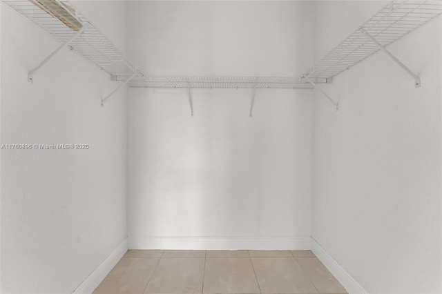 spacious closet featuring light tile patterned floors