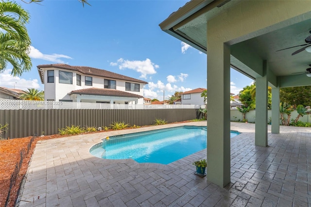 view of swimming pool featuring a ceiling fan, a patio, a fenced backyard, and a fenced in pool