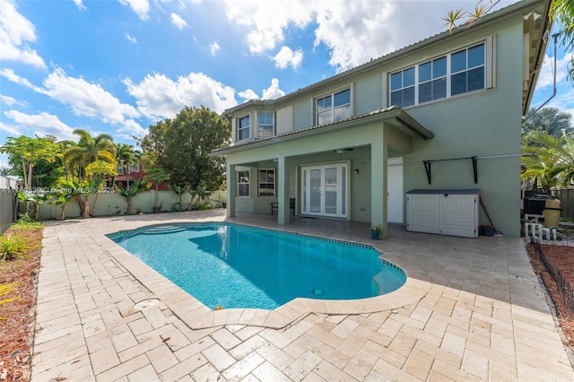 view of swimming pool featuring french doors, a fenced in pool, a patio, and a fenced backyard