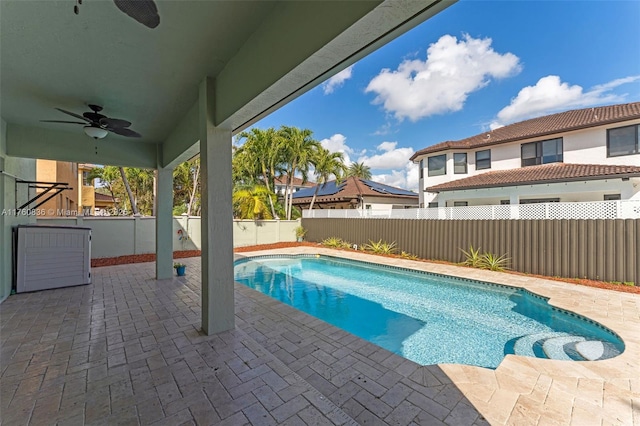 view of pool with a fenced backyard, a ceiling fan, a fenced in pool, and a patio area