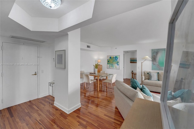 interior space featuring wood finished floors, visible vents, and baseboards