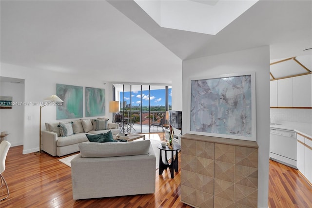 living area with light wood-style flooring and expansive windows