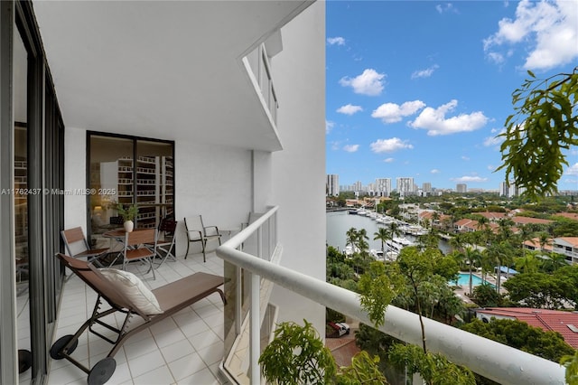 balcony featuring a view of city and a water view