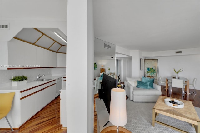 living room with visible vents and light wood-type flooring