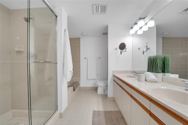 full bath with tile patterned floors, visible vents, tiled shower, and a sink