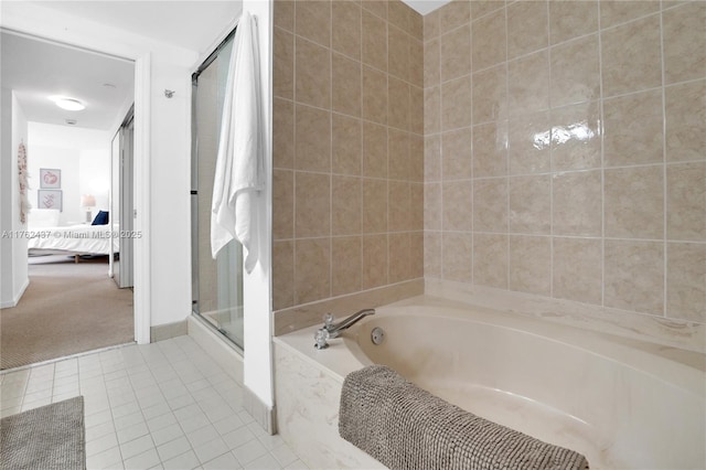 ensuite bathroom with tile patterned flooring, connected bathroom, a bath, and a shower stall