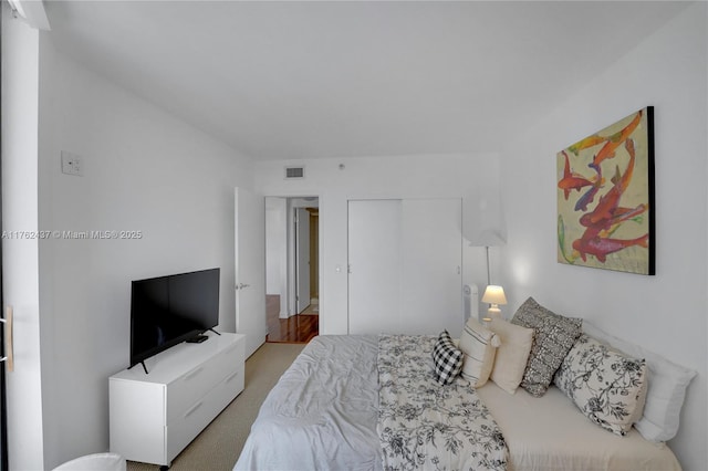 bedroom featuring visible vents and a closet