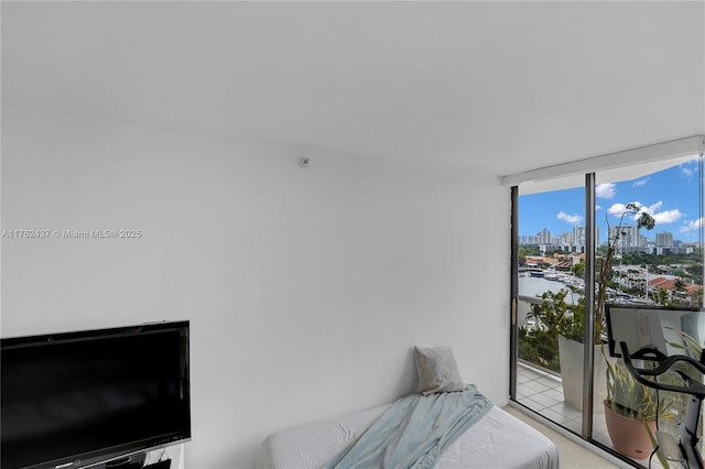 bedroom with a city view and expansive windows