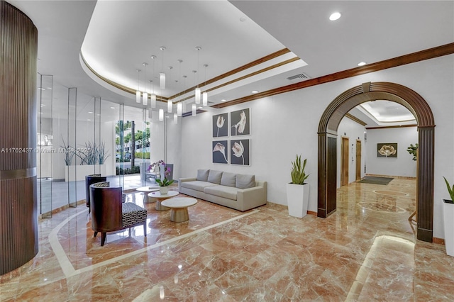 living room featuring arched walkways, visible vents, marble finish floor, and a raised ceiling