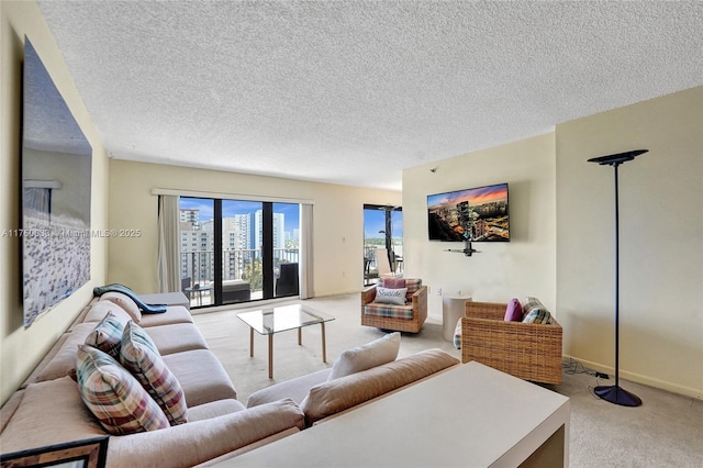 carpeted living room featuring baseboards and a textured ceiling