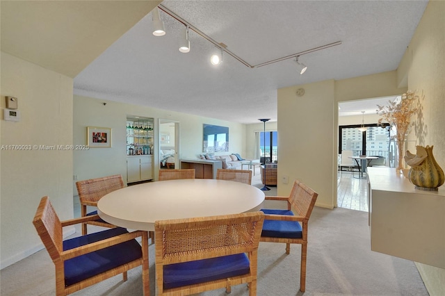 dining area featuring light colored carpet