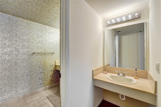 bathroom featuring vanity and baseboards