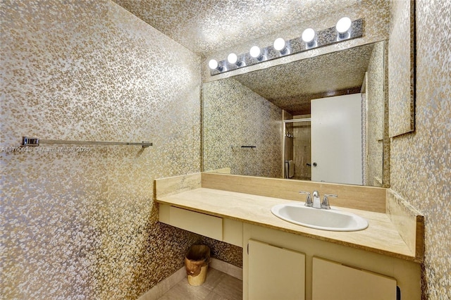 full bathroom with tile patterned floors, a shower stall, and vanity