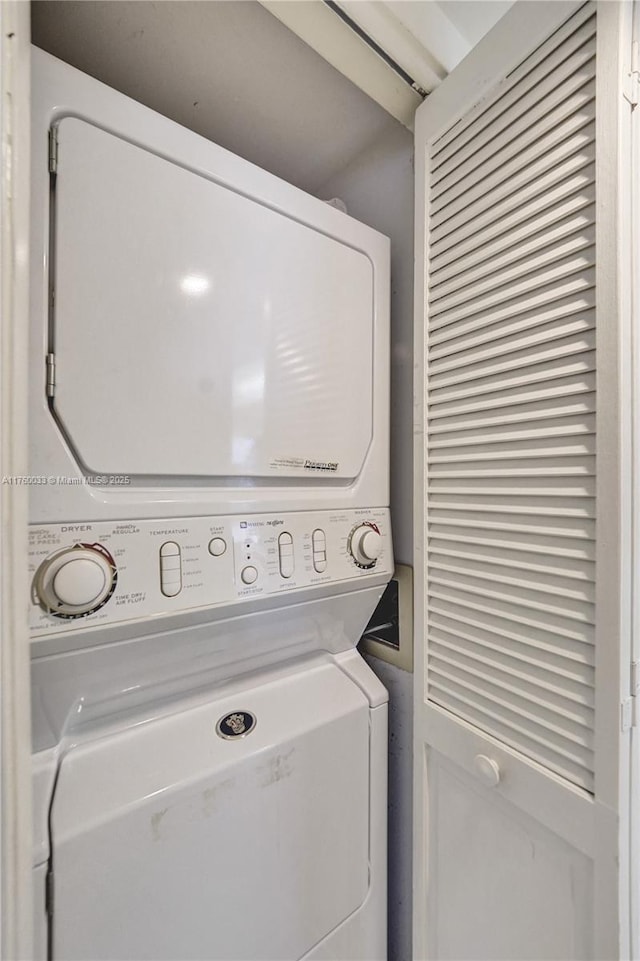 clothes washing area with laundry area and stacked washer and clothes dryer