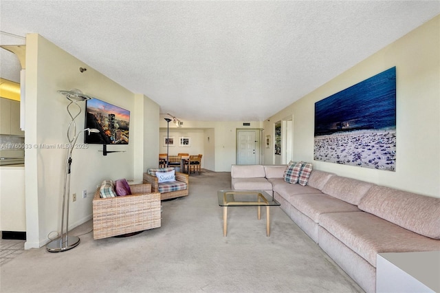 carpeted living room featuring a textured ceiling