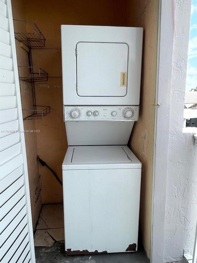 laundry room featuring stacked washer and dryer and laundry area