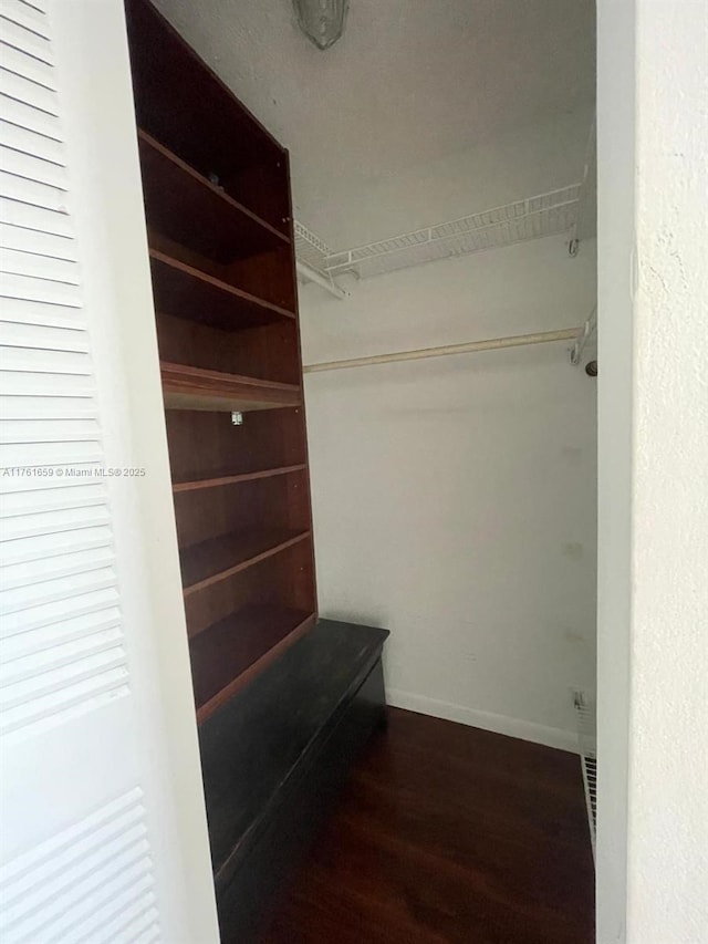 spacious closet with wood finished floors