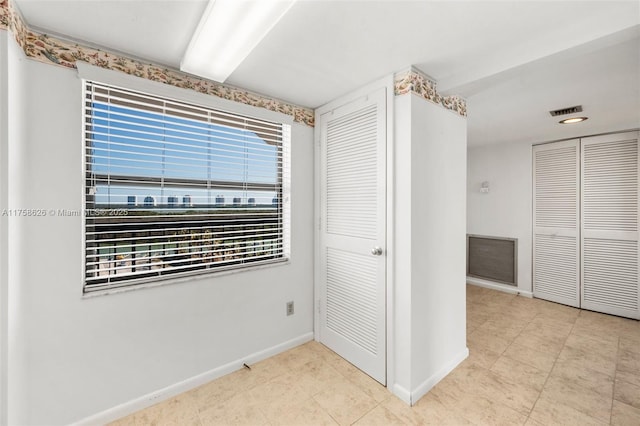 unfurnished bedroom featuring baseboards, visible vents, and a closet