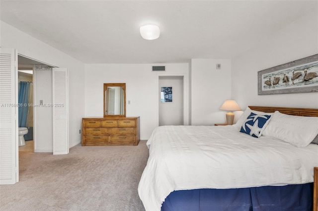 carpeted bedroom featuring visible vents