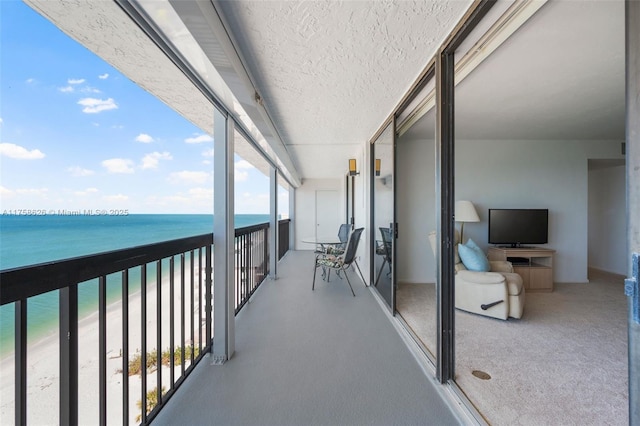 balcony featuring a beach view