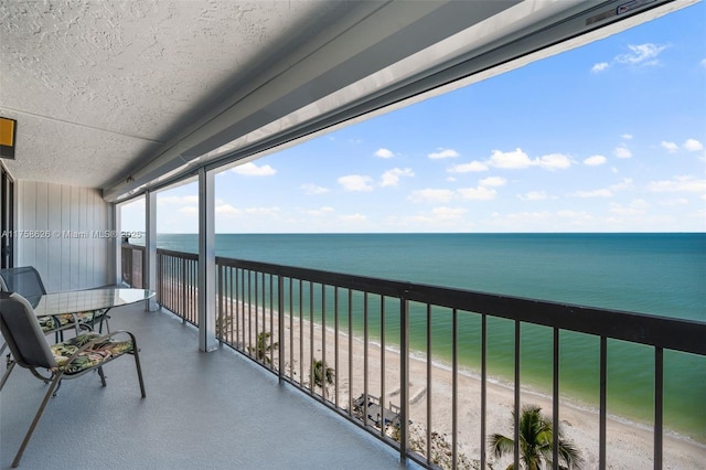 balcony with a beach view and a water view