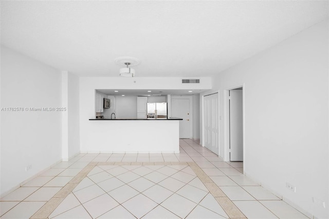 5601 Collins Ave Unit 1604, Miami Beach, FL 33140 - unfurnished living room featuring light tile patterned floors, visible vents, and recessed lighting