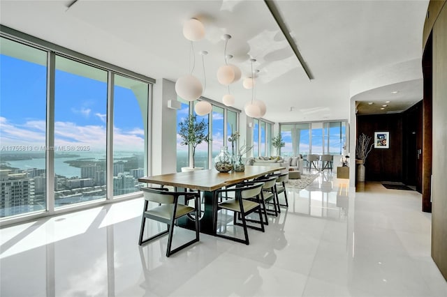 dining space featuring tile patterned flooring and expansive windows