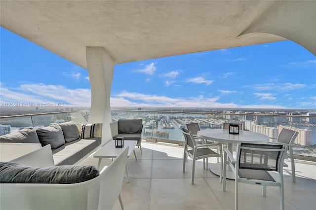 view of patio featuring an outdoor living space, a water view, and a balcony