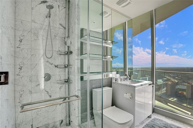 full bathroom with vanity, toilet, visible vents, and a marble finish shower