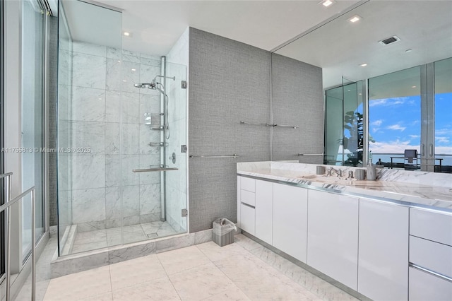 full bath with vanity, visible vents, and a stall shower