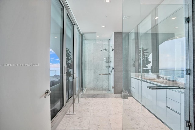 full bathroom with visible vents, a stall shower, and vanity