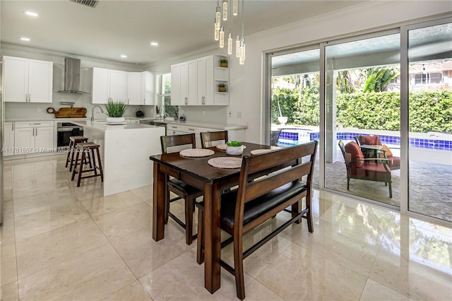 dining area with recessed lighting, marble finish floor, and ornamental molding