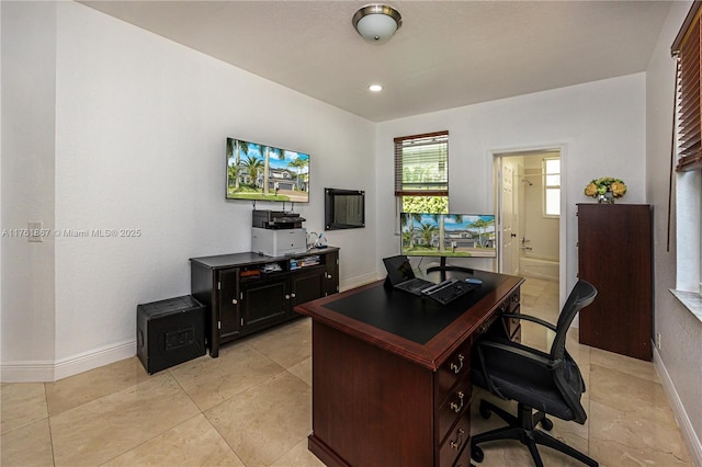 home office featuring light tile patterned floors and baseboards