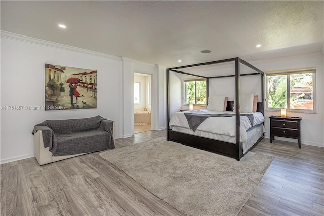 bedroom with recessed lighting, wood finished floors, baseboards, and a textured ceiling