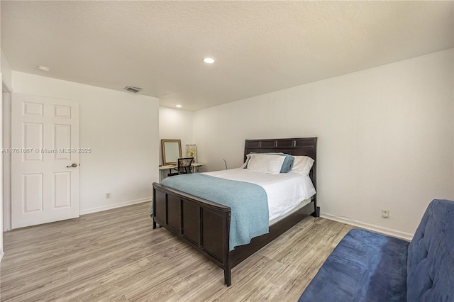 bedroom featuring recessed lighting, visible vents, baseboards, and light wood finished floors