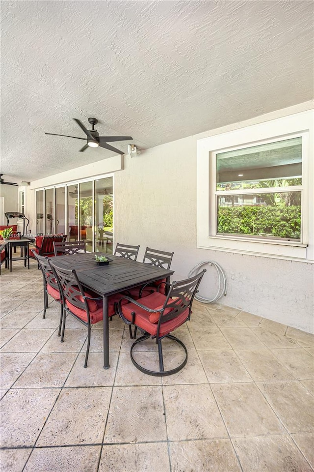 view of patio with outdoor dining area and ceiling fan