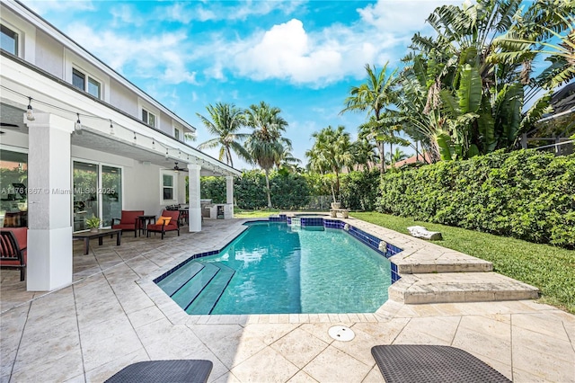 view of pool with a patio, a grill, a ceiling fan, and a pool with connected hot tub