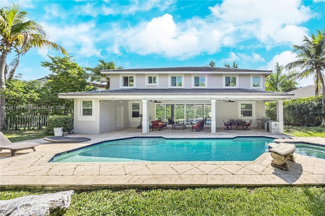 outdoor pool featuring a patio, fence, an in ground hot tub, ceiling fan, and outdoor lounge area