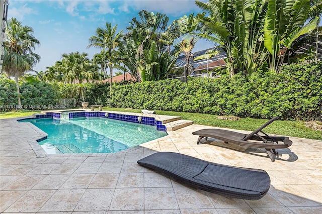 view of swimming pool featuring a patio area and a pool with connected hot tub