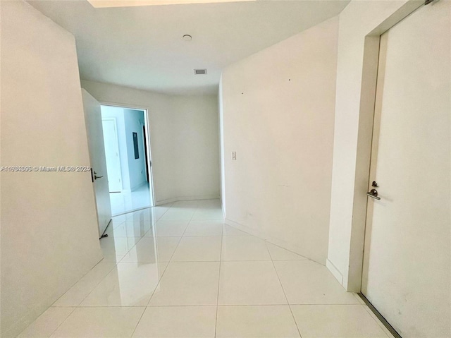 hall featuring light tile patterned floors