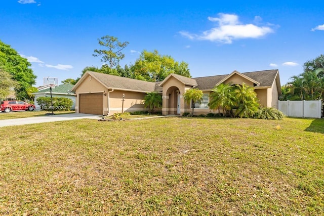 ranch-style house featuring a front yard, fence, driveway, an attached garage, and stucco siding