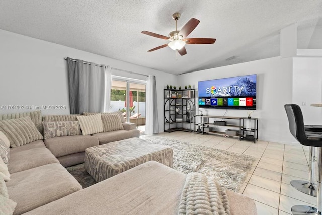 tiled living room featuring lofted ceiling, a textured ceiling, and ceiling fan