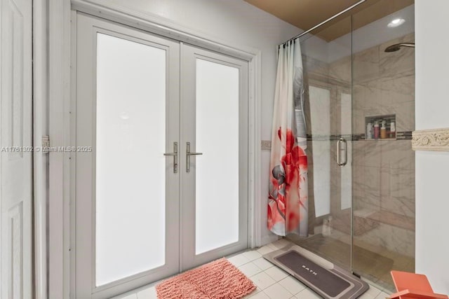 full bath with french doors, a shower stall, and tile patterned flooring