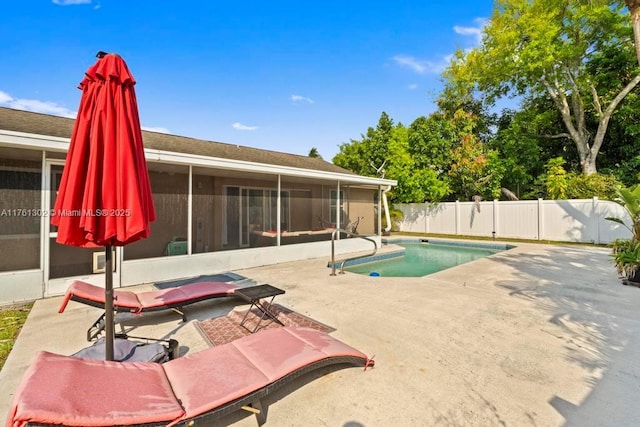 view of swimming pool with a patio, a fenced backyard, a fenced in pool, and a sunroom