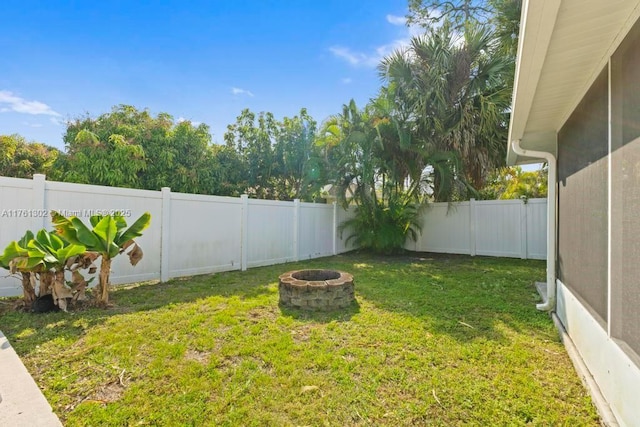 view of yard with a fenced backyard and an outdoor fire pit