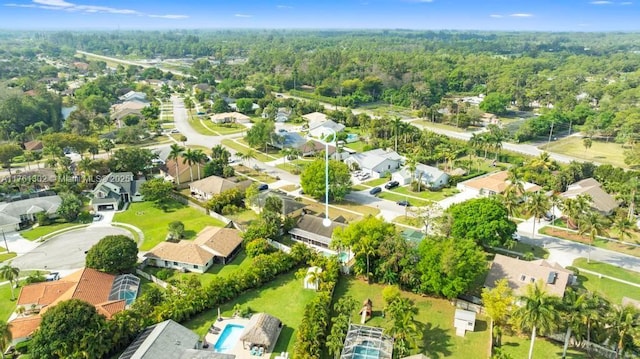 birds eye view of property featuring a view of trees and a residential view