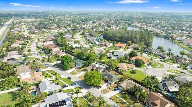 drone / aerial view with a residential view and a water view